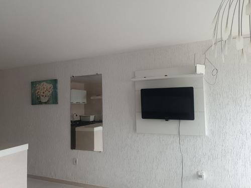 a flat screen tv on a wall in a room at loft barbudo in Araruama