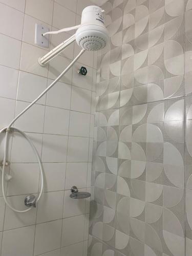a shower with a shower head in a bathroom at Apartamento Praia Bela Vista in Angra dos Reis