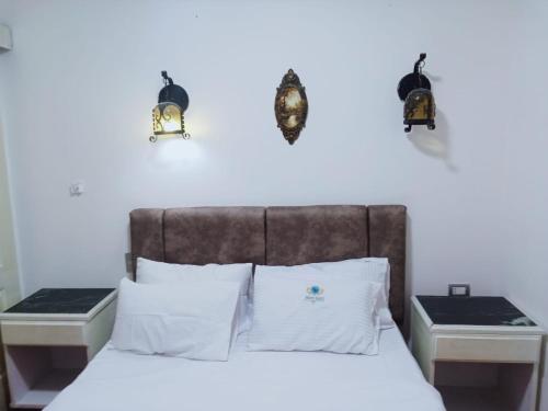 a bedroom with a bed with two night stands at 321or322 the finest Porto Marina Chalets Tower 3 in El Alamein