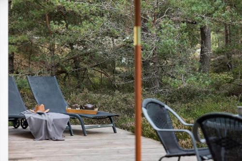 a table and chairs on a wooden deck at 2707-Nexo-Th-Kofoedsvej-2 in Dueodde