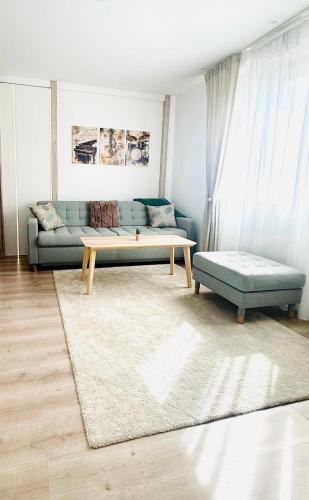 a living room with a couch and a coffee table at Modern Apartment in City Center in Iaşi