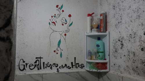 a small bathroom with a sign on the wall at Sidi Bouzid Guesthouse in Safi