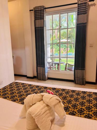 a towel on the floor in a room with a window at Inn Sea Horizon Ahungalla in Ahungalla