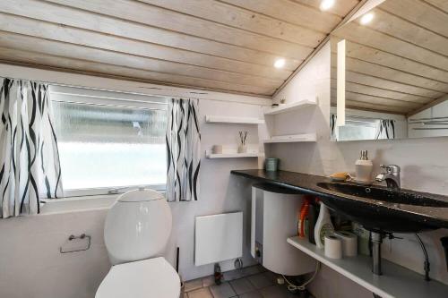 a small bathroom with a toilet and a sink at C11729-Hemmet-Vester-Faelled-192-I1 in Falen