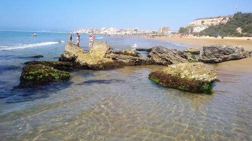 a beach with some rocks in the water at Casa Paola - A due passi dal mare in Pozzallo