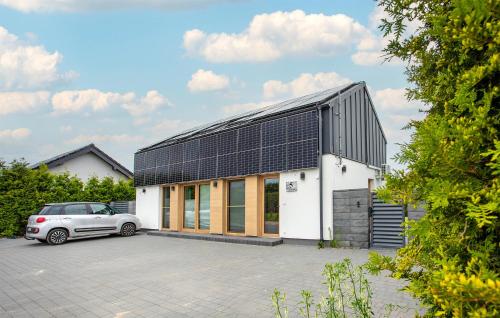 a white house with solar panels on it at Amazing Apartment In Nowecin With Wifi in Nowecin