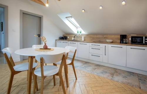a kitchen with a table and chairs in a kitchen at Amazing Apartment In Nowecin With Wifi in Nowecin