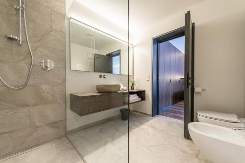 a bathroom with a sink and a glass shower at Mountain Residence Montana in Santa Maddalena in Casies