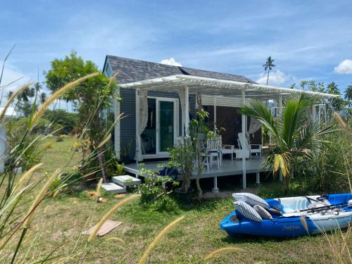 a small house with a boat in front of it at Beachfront Tiny House, Koh Samui, Thailand with FREE Rowboat in Amphoe Koh Samui