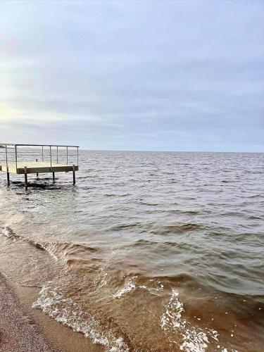 a pier in the water next to the beach at C11349-Tarm-Stikkelsbaervej-43 in Højsand
