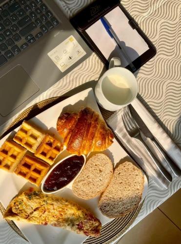 a table topped with a plate of bread and toast at Dolce Vita Resort Hotel in Bujumbura