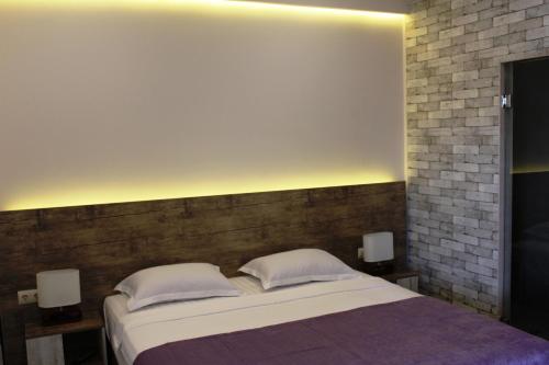 Ένα ή περισσότερα κρεβάτια σε δωμάτιο στο RG Urban Hotel