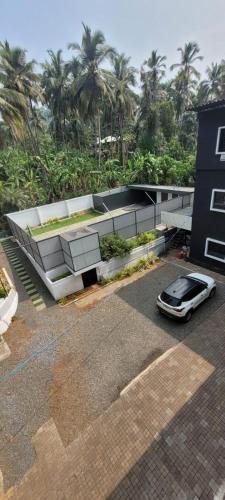 a car parked in a parking lot in front of a building at Anam residence in Tāzhekkod