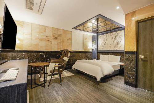 a hotel room with a bed and a desk at Signature Tourist Hotel in Seoul