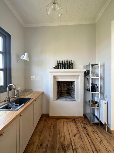 a kitchen with a fireplace in the middle of a room at Entire House & Garden - Chokhelis' Telavi Retreat in Tʼelavi