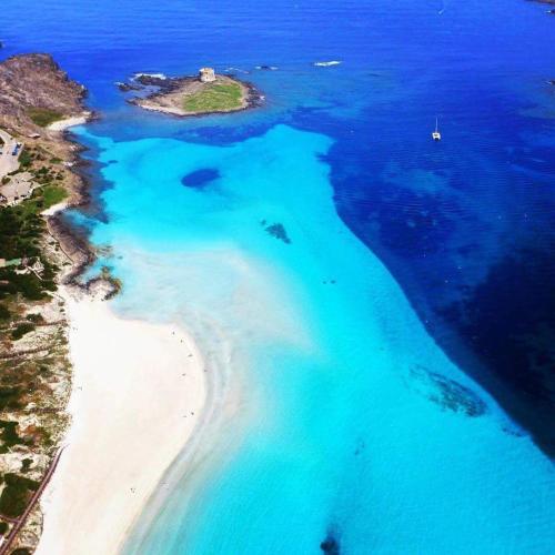 an aerial view of an island in the ocean at Lina Hotel in Stintino