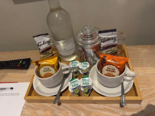 a tray with two cups of coffee on a table at Red Lion Inn Wybunbury in Wybunbury
