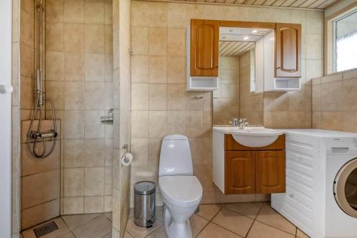 a bathroom with a toilet and a sink and a shower at C11352-Tarm-Hjortevej-8 in Højsand