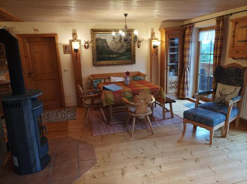 a living room with a table and a fireplace at Ferienwohnungen Dopplerhof in Piding