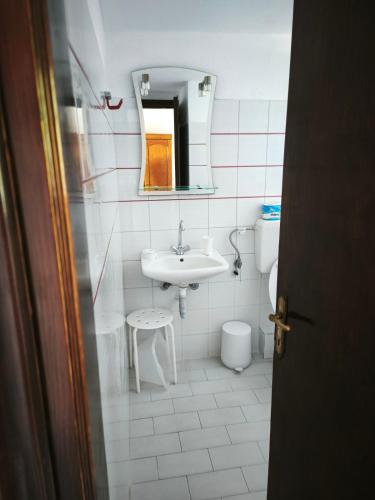 a bathroom with a sink and a toilet and a mirror at Villa Frideriki in Agia Paraskevi