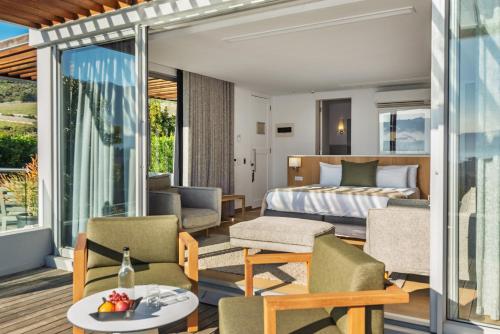 a hotel room with a bed and a balcony at Clouds Estate in Stellenbosch