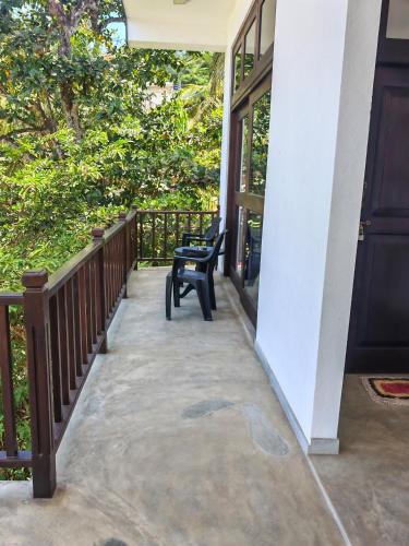 a chair on the porch of a house at Waves Hiri Sea View in Hiriketiya