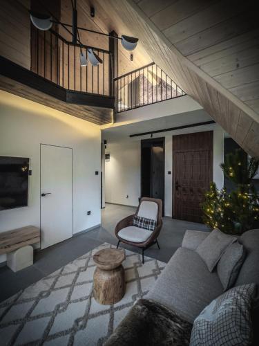 a living room with a couch and a table at Anika - Mountain Home in Divčibare