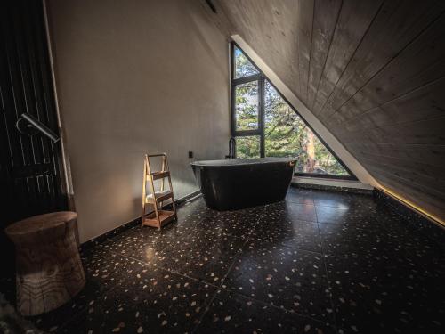 a bathroom with a large tub and a window at Anika - Mountain Home in Divčibare