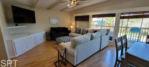 a living room with a couch and a tv at Large 3 bedr Bay Views Pool Great Deck condo in South Padre Island