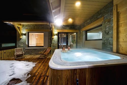 a large bath tub with two babies in it at Hôtel-Chalet Les Ecureuils Spa & Sauna in Le Grand-Bornand