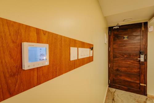 a room with a door and a wall at Hotel Urban Bella in Kozhikode