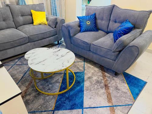 a living room with a couch and a table at Kija Homes Bnb in Ruiru
