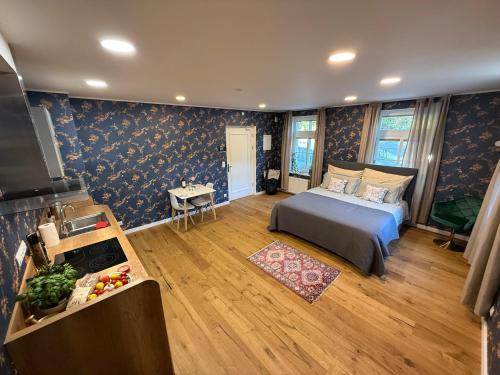 a bedroom with a bed in a room with blue wallpaper at Mulino Apartments in Borek