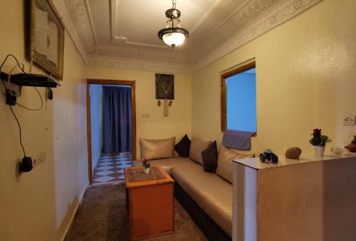 a living room with a couch and a table at Relax House in Ikhorbane