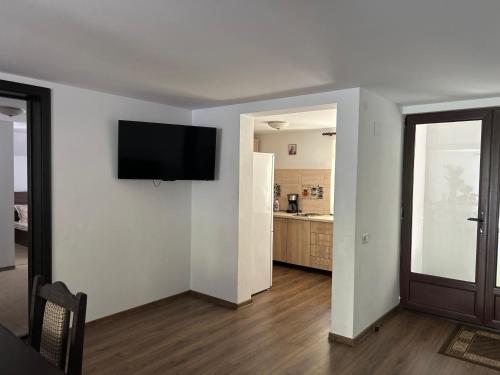 a living room with a flat screen tv on a wall at Casa din Codru in Şimon