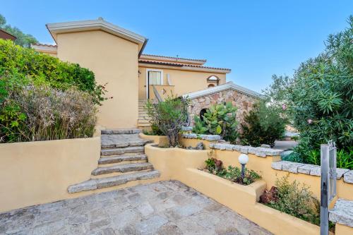 a home with a staircase leading up to a house at Villino Tiriddò Porto San Paolo in Porto San Paolo