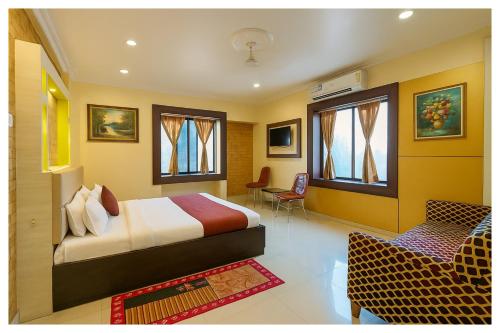 a hotel room with a bed and a chair at Hotel SS - Piper Near Sea Beach And Jagannath Temple in Puri