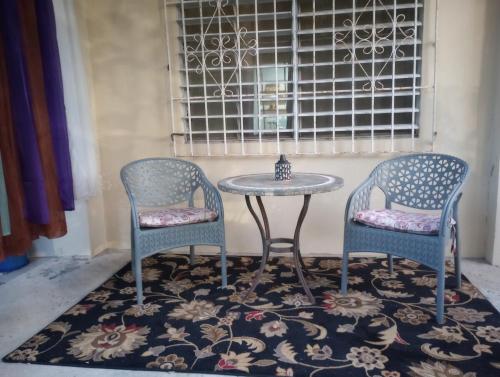 two chairs and a table and a table and chairs at Casa Coco Cabana 