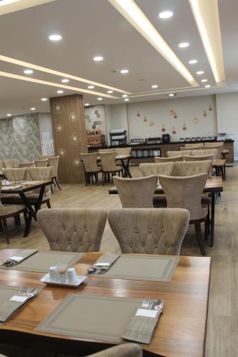 a dining room with wooden tables and chairs at ETÜ Konukevi 