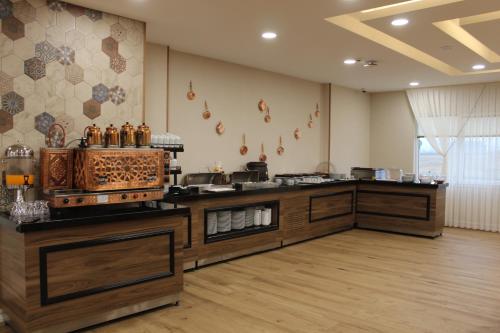 a large room with a kitchen with a counter top at ETÜ Konukevi 