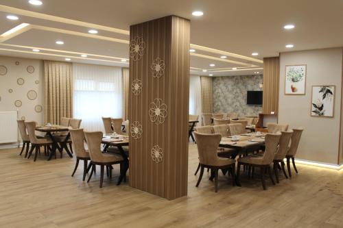 a conference room with tables and chairs and a podium at ETÜ Konukevi 