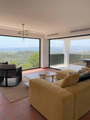 a living room with a couch and a large window at A Design Casa in Own Private Hills for Adult Only in Alginet