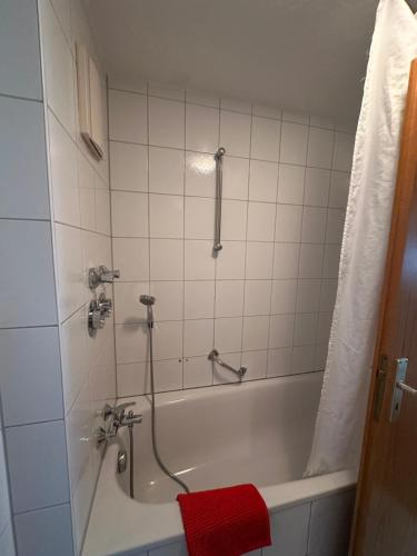 a bathroom with a bath tub with a red towel at Apartment FIVE - EP Ticket Garantie in Rust