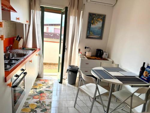 a small kitchen with a table and a table and chairs at ZIGI - Beautiful, sunny apartment, 70m2, close to the sea in Scalea