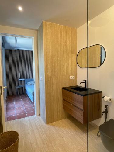 a bathroom with a sink and a mirror and a tub at A Design Casa in Own Private Hills for Adult Only in Alginet