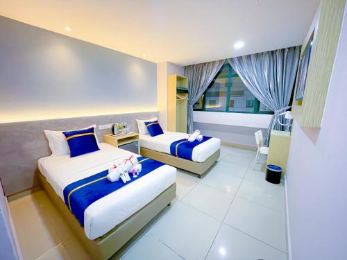 Ένα ή περισσότερα κρεβάτια σε δωμάτιο στο StarQ Hotel