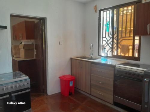 a kitchen with a sink and a window at SouthCoast Outdoors in Ukunda