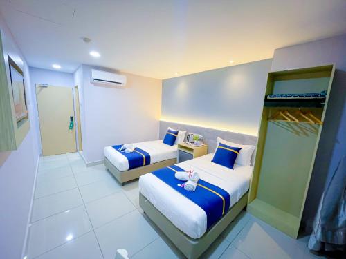 Ένα ή περισσότερα κρεβάτια σε δωμάτιο στο StarQ Hotel