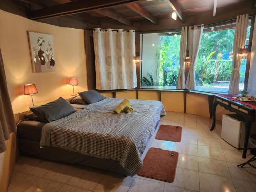 a bedroom with a bed with a teddy bear on it at RELAX ECO Life Center-Khao Lak in Khao Lak