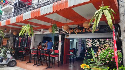 a restaurant with tables and chairs in front of it at Rich Bar & House in Pattaya
